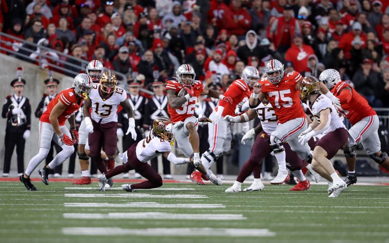 Nov 18, 2023; Columbus, Ohio, USA;  Ohio State Buckeyes running back TreVeyon Henderson (32) runs the football during the second quarter against the Minnesota Golden Gophers at Ohio Stadium. Mandatory Credit: Joseph Maiorana-USA TODAY Sports
