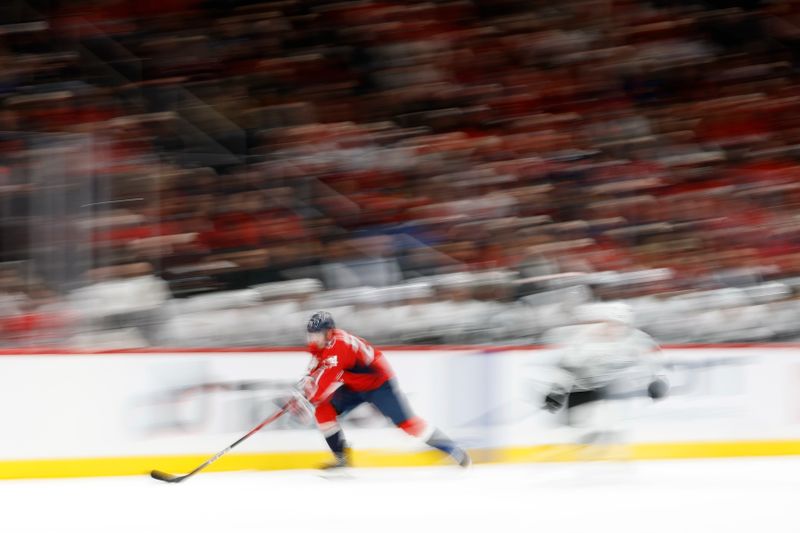 Nov 17, 2025; Washington, District of Columbia, USA; Washington Capitals center Connor McMichael (24) skates with the puck against as Los Angeles Kings defenseman Mikey Anderson (44) chases during the third period at Capital One Arena. Mandatory Credit: Geoff Burke-Imagn Images