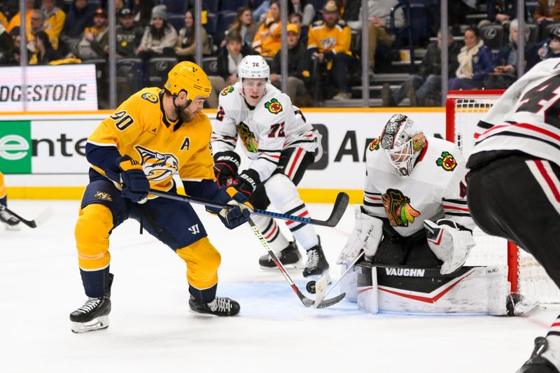 Jan 16, 2025; Nashville, Tennessee, USA;  Chicago Blackhawks goaltender Arvid Soderblom (40) blocks the shot of Nashville Predators center Ryan O'Reilly (90) during the third period at Bridgestone Arena. Mandatory Credit: Steve Roberts-Imagn Images