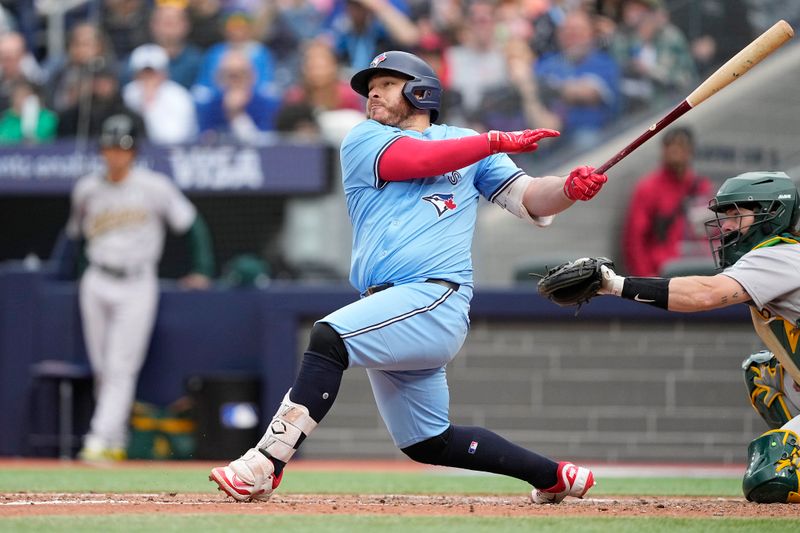 Jun 1, 2025; Toronto, Ontario, CAN; Toronto Blue Jays catcher Alejandro Kirk (30) hits an RBI double against the Oakland Athletics during the fifth inning at Rogers Centre. Mandatory Credit: John E. Sokolowski-Imagn Images