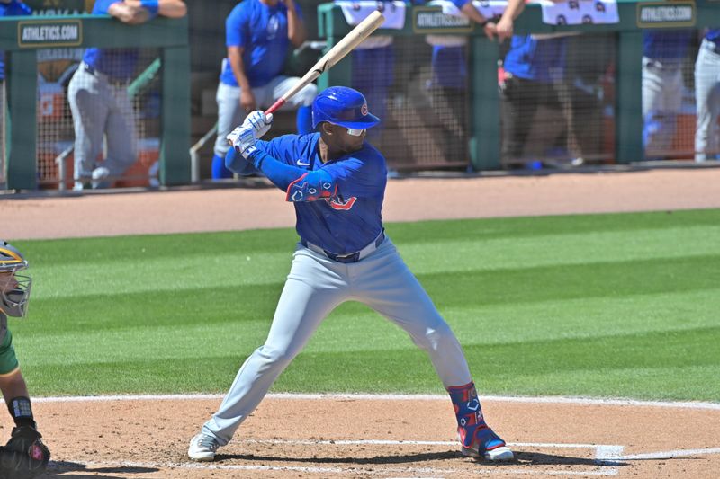 Mar 20, 2024; Mesa, Arizona, USA;  Chicago Cubs center fielder Alexander Canario (4) at bat in the third inning against the Oakland Athletics during a spring training game at Hohokam Stadium. Mandatory Credit: Matt Kartozian-USA TODAY Sports