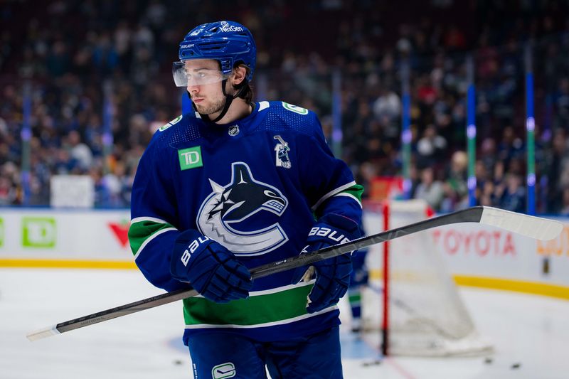 Dec 14, 2023; Vancouver, British Columbia, CAN; Vancouver Canucks defenseman Quinn Hughes (43) warms up wearing Roberto Luongo   s number 1 jersey prior to an on ice presentation before a game against the Florida Panthers at Rogers Arena. Mandatory Credit: Bob Frid-USA TODAY Sports