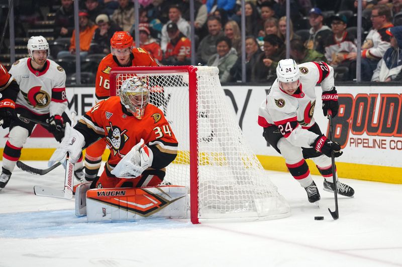 Nov 20, 2025; Anaheim, California, USA; Anaheim Ducks goaltender Petr Mrazek (34) defends the goal against Ottawa Senators center Dylan Cozens (24) in the first period at Honda Center. Mandatory Credit: Kirby Lee-Imagn Images