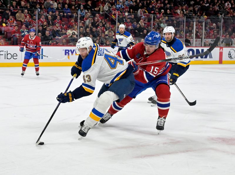 Feb 11, 2024; Montreal, Quebec, CAN; St.Louis Blues defenseman Calle Rosen (43) plays the puck and Montreal Canadiens forward Alex Newhook (15) defends during the second period at the Bell Centre. Mandatory Credit: Eric Bolte-USA TODAY Sports