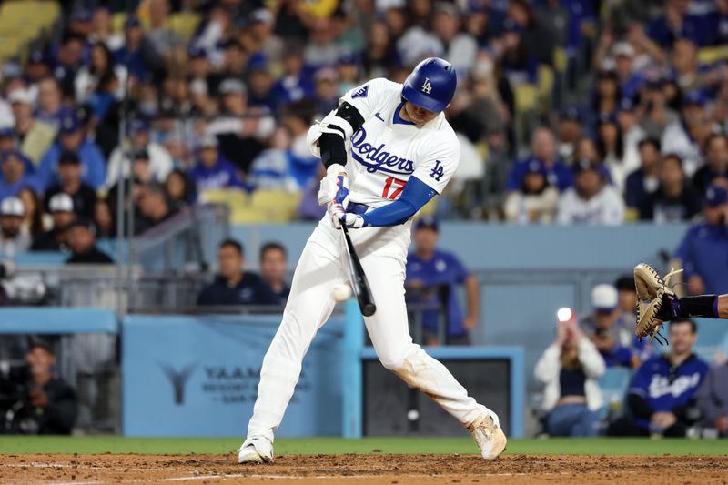 Jun 1, 2024; Los Angeles, California, USA;  Los Angeles Dodgers designated hitter Shohei Ohtani (17) hits a single during the seventh inning against the Colorado Rockies at Dodger Stadium. Mandatory Credit: Kiyoshi Mio-USA TODAY Sports