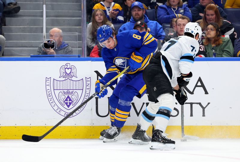 Nov 4, 2025; Buffalo, New York, USA;  Buffalo Sabres defenseman Michael Kesselring (8) and Utah Mammoth right wing JJ Peterka (77) go after the puck during the second period at KeyBank Center. Mandatory Credit: Timothy T. Ludwig-Imagn Images