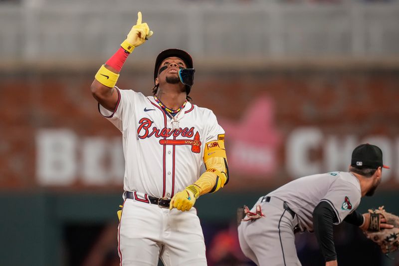Apr 5, 2024; Cumberland, Georgia, USA; Atlanta Braves outfielder Ronald Acuna Jr. (13) reacts after hitting a double to drive in a run against the Arizona Diamondbacks during the eighth inning at Truist Park. Mandatory Credit: Dale Zanine-USA TODAY Sports