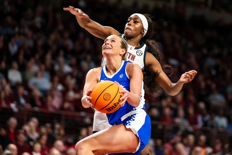 Jan 15, 2024; Columbia, South Carolina, USA; Kentucky Wildcats guard Maddie Scherr (22) drives past South Carolina Gamecocks guard Raven Johnson (25) in the second half at Colonial Life Arena. Mandatory Credit: Jeff Blake-USA TODAY Sports