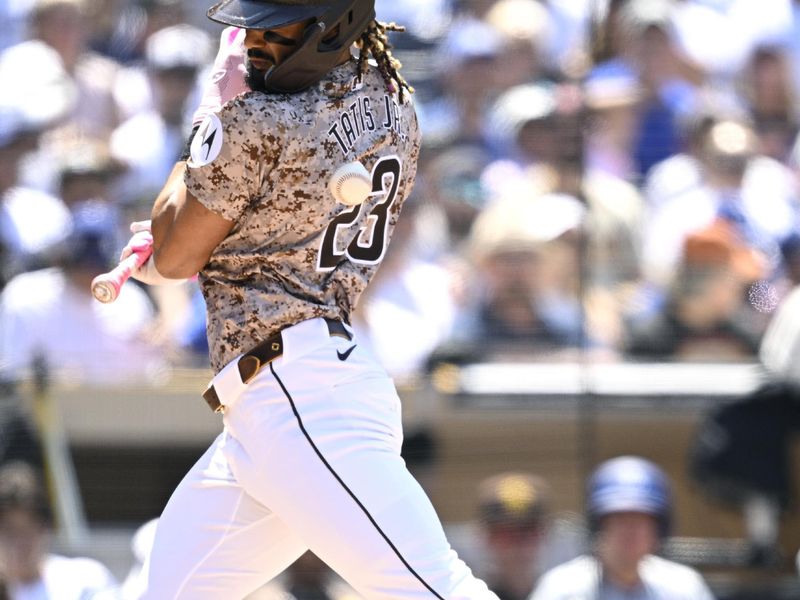 May 12, 2024; San Diego, California, USA; San Diego Padres right fielder Fernando Tatis Jr. (23) is hit by a pitch during the fourth inning against the Los Angeles Dodgers at Petco Park. Mandatory Credit: Orlando Ramirez-USA TODAY Sports