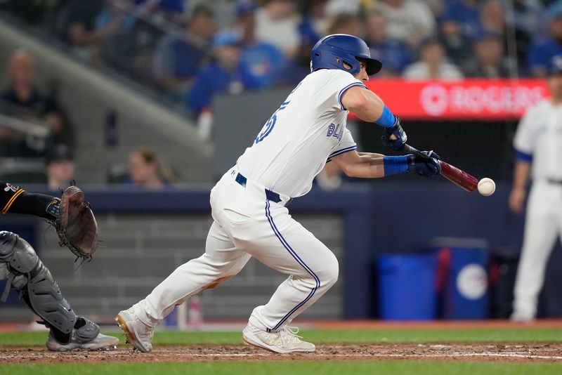 Jun 2, 2024; Toronto, Ontario, CAN; Toronto Blue Jays center fielder Daulton Varsho (25) hits a bunt single against the Pittsburgh Pirates during the sixth inning at Rogers Centre. Mandatory Credit: John E. Sokolowski-USA TODAY Sports