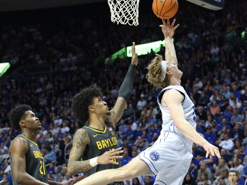 Feb 20, 2024; Provo, Utah, USA; Brigham Young Cougars guard Richie Saunders (15) goes to the basket against Baylor Bears forward Jalen Bridges (11) during the second half at Marriott Center. Mandatory Credit: Rob Gray-USA TODAY Sports