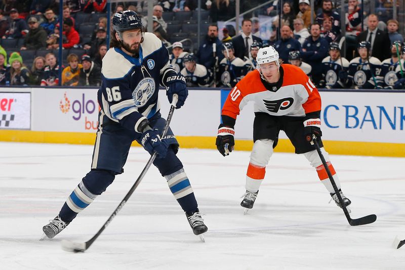 Jan 14, 2025; Columbus, Ohio, USA; Columbus Blue Jackets right wing Kirill Marchenko (86) wrists a shot on goalasPhiladelphia Flyers right wing Bobby Brink (10) trails the play during the first period at Nationwide Arena. Mandatory Credit: Russell LaBounty-Imagn Images