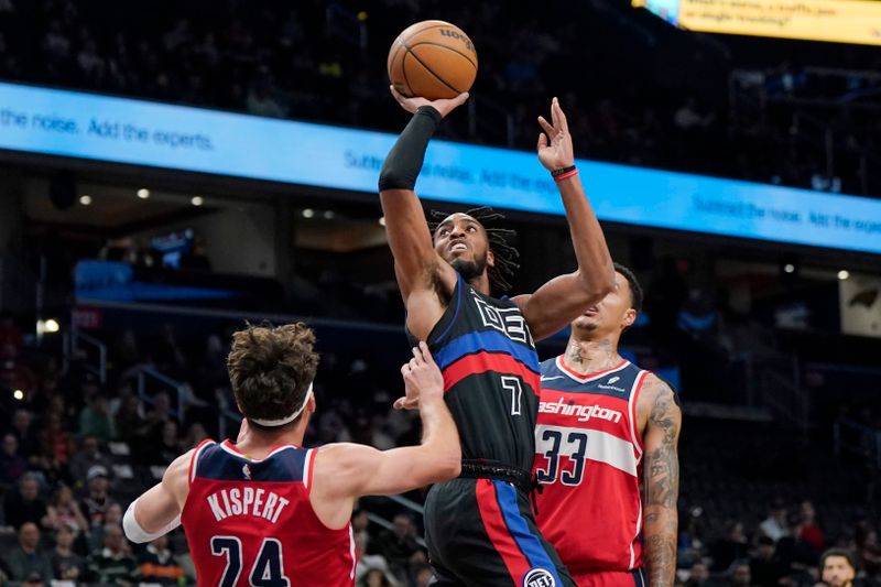 WASHINGTON, DC - MARCH 29: Troy Brown Jr. #7 of the Detroit Pistons shoots against Corey Kispert #24 of the Washington Wizards and Kyle Kuzma #33 during the first half at Capital One Arena on March 29, 2024 in Washington, DC. NOTE TO USER: User expressly acknowledges and agrees that, by downloading and or using this photograph, User is consenting to the terms and conditions of the Getty Images License Agreement. (Photo by Jess Rapfogel/Getty Images)