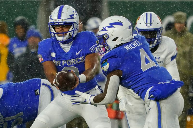 Oct 28, 2023; Fort Collins, Colorado, USA;  Air Force Falcons quarterback Zac Larrier (9) hands off to Air Force Falcons fullback Emmanuel Michel (4) at Sonny Lubick Field at Canvas Stadium. Mandatory Credit: Michael Madrid-USA TODAY Sports