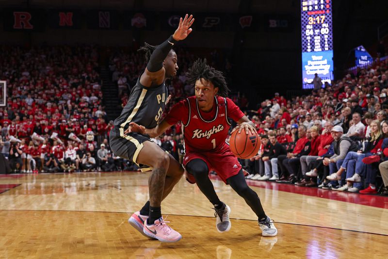 Jan 28, 2024; Piscataway, New Jersey, USA; Rutgers Scarlet Knights guard Jamichael Davis (1) dribbles against Purdue Boilermakers guard Lance Jones (55) during the second half at Jersey Mike's Arena. Mandatory Credit: Vincent Carchietta-USA TODAY Sports