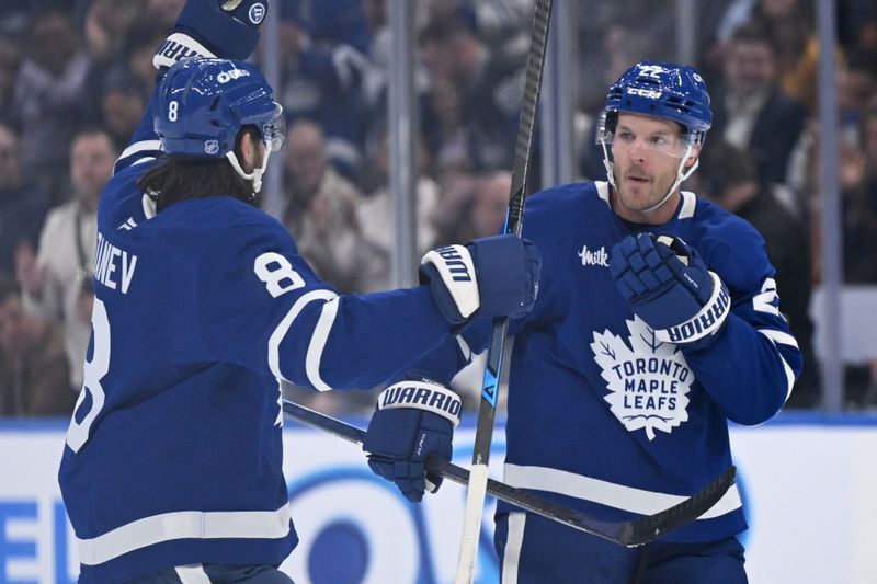 Oct 14, 2025; Toronto, Ontario, CAN;   Toronto Maple Leafs defenseman Jake McCabe (22) celebrates with defenseman Chris Tanev (8) after scoring a goal against the Nashville Predators in the first period at Scotiabank Arena. Mandatory Credit: Dan Hamilton-Imagn Images