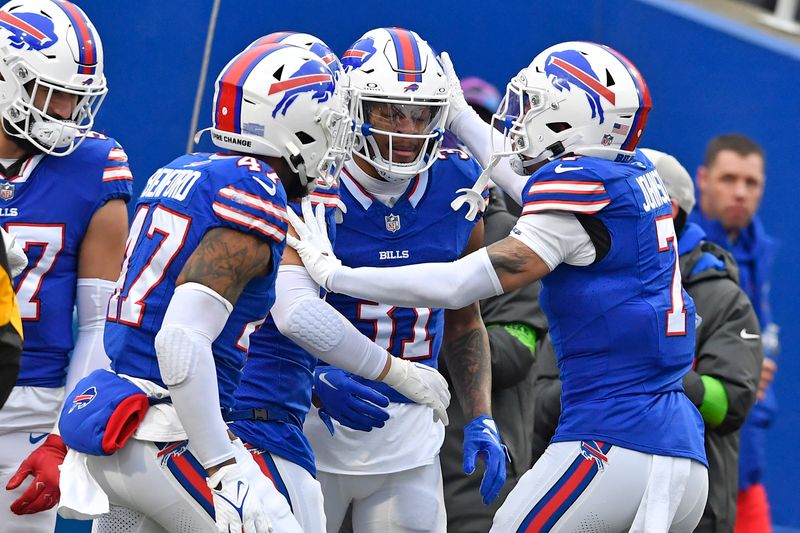 Buffalo Bills cornerback Rasul Douglas (31) celebrates his interception with teammates during the first half of an NFL football game against the New England Patriots in Orchard Park, N.Y., Sunday, Dec. 31, 2023. (AP Photo/Adrian Kraus)