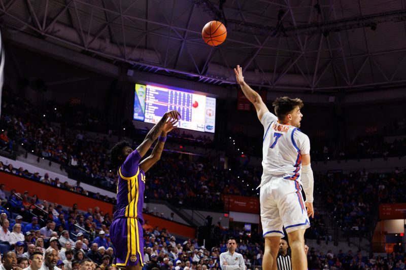 Jan 20, 2026; Gainesville, Florida, USA; Louisiana State Tigers guard Rashad King (4) attempts a three point basket over Florida Gators guard Urban Klavzar (7) during the first half at Exactech Arena at the Stephen C. O'Connell Center. Mandatory Credit: Matt Pendleton-Imagn Images