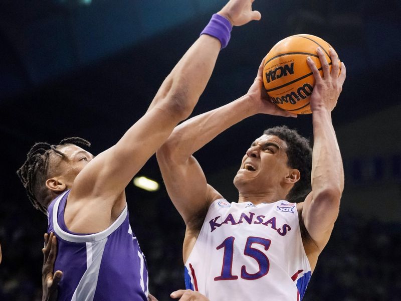 Jan 31, 2023; Lawrence, Kansas, USA; Kansas Jayhawks guard Kevin McCullar Jr. (15) shoots against Kansas State Wildcats forward Keyontae Johnson (11) during the second half at Allen Fieldhouse. Mandatory Credit: Jay Biggerstaff-USA TODAY Sports