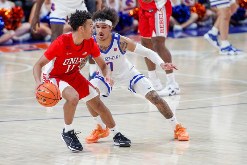 Jan 16, 2024; Boise, Idaho, USA; UNLV Rebels guard Dedan Thomas Jr. (11) works against Boise State Broncos guard Roddie Anderson III (0) during the second half at ExtraMile Arena. UNLV beats Boise State 68-64. Mandatory Credit: Brian Losness-USA TODAY Sports

