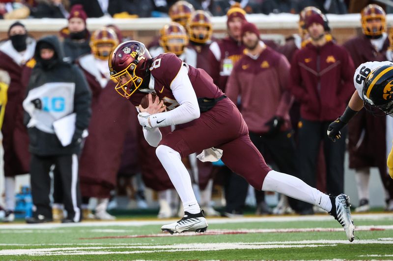 Nov 19, 2022; Minneapolis, Minnesota, USA; Minnesota Golden Gophers quarterback Athan Kaliakmanis (8) runs the ball against the Iowa Hawkeyes during the second quarter at Huntington Bank Stadium. Mandatory Credit: Matt Krohn-USA TODAY Sports