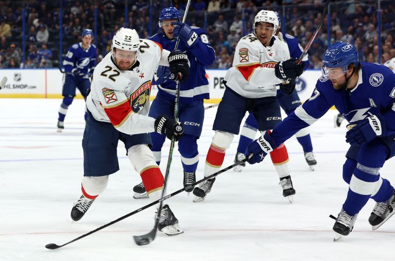 Oct 5, 2023; Tampa, Florida, USA;Florida Panthers center Zac Dalpe (22) shoots as Tampa Bay Lightning defenseman Victor Hedman (77) defends during the first period at Amalie Arena. Mandatory Credit: Kim Klement Neitzel-USA TODAY Sports