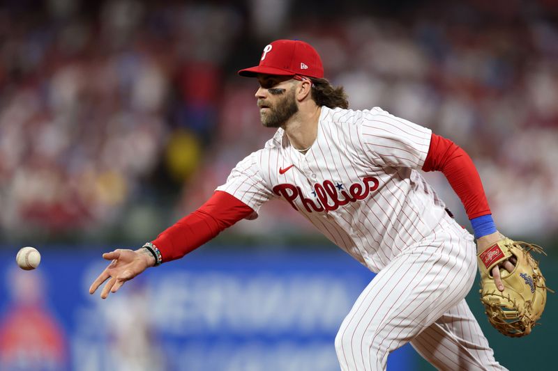 Oct 4, 2023; Philadelphia, Pennsylvania, USA; Philadelphia Phillies designated hitter Bryce Harper (3) tosses the ball to first base against the Miami Marlins during the fourth inning for game two of the Wildcard series for the 2023 MLB playoffs at Citizens Bank Park. Mandatory Credit: Bill Streicher-USA TODAY Sports