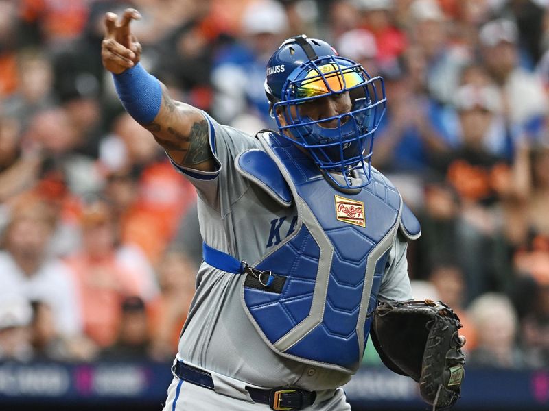 Oct 1, 2024; Baltimore, Maryland, USA; Kansas City Royals catcher Salvador Perez (13) throws to first base after Baltimore Orioles catcher Adley Rutschman (not pictured) strikes out in game one of the Wild Card round for the 2024 MLB Playoffs at Oriole Park at Camden Yards. Mandatory Credit: Tommy Gilligan-Imagn Images