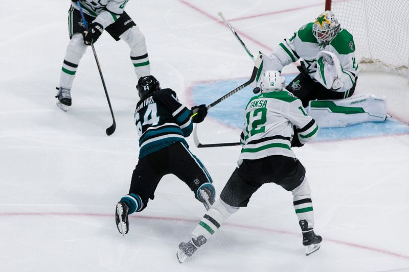 Mar 5, 2024; San Jose, California, USA; San Jose Sharks center Mikael Granlund (64) shoots and scores as Dallas Stars center Radek Faksa (12) and goaltender Jake Oettinger (29) defend during the third period at SAP Center at San Jose. Mandatory Credit: John Hefti-USA TODAY Sports