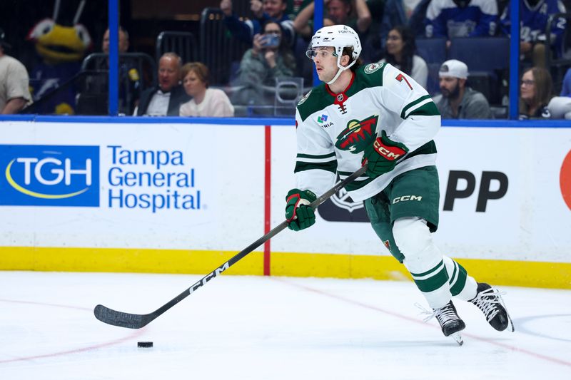 Mar 24, 2026; Tampa, Florida, USA; Minnesota Wild defenseman Brock Faber (7) controls the puck against the Tampa Bay Lightning in the first period at Benchmark International Arena. Mandatory Credit: Nathan Ray Seebeck-Imagn Images