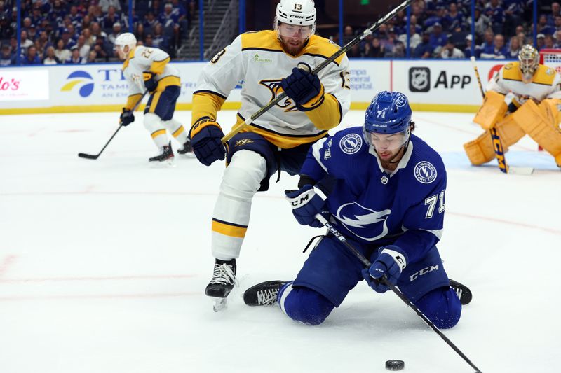 Oct 10, 2023; Tampa, Florida, USA; Tampa Bay Lightning center Anthony Cirelli (71) skates with the puck as  Nashville Predators center Yakov Trenin (13) defends during the first period at Amalie Arena. Mandatory Credit: Kim Klement Neitzel-USA TODAY Sports