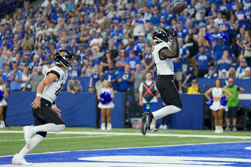 Jacksonville Jaguars running back Tank Bigsby (4) celebrates after scoring during an NFL football game against the Indianapolis Colts, Sunday, Sept. 10, 2023, in Indianapolis. (AP Photo/Jeff Dean)