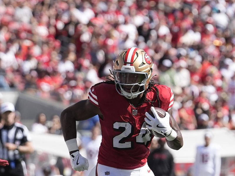 San Francisco 49ers running back Jordan Mason (24) runs against the Arizona Cardinals during the first half of an NFL football game in Santa Clara, Calif., Sunday, Oct. 6, 2024. (AP Photo/Godofredo A. Vásquez)