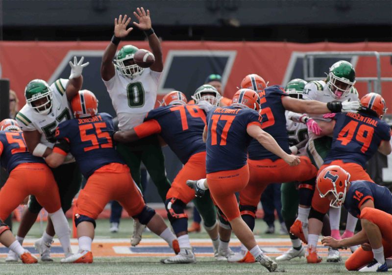 Oct 2, 2021; Champaign, Illinois, USA;  Charlotte 49ers defensive end Markees Watts (0) attempts a block on the point after kick of Illinois Fighting Illini kicker James McCourt (17) in the second half at Memorial Stadium. Mandatory Credit: Ron Johnson-USA TODAY Sports



