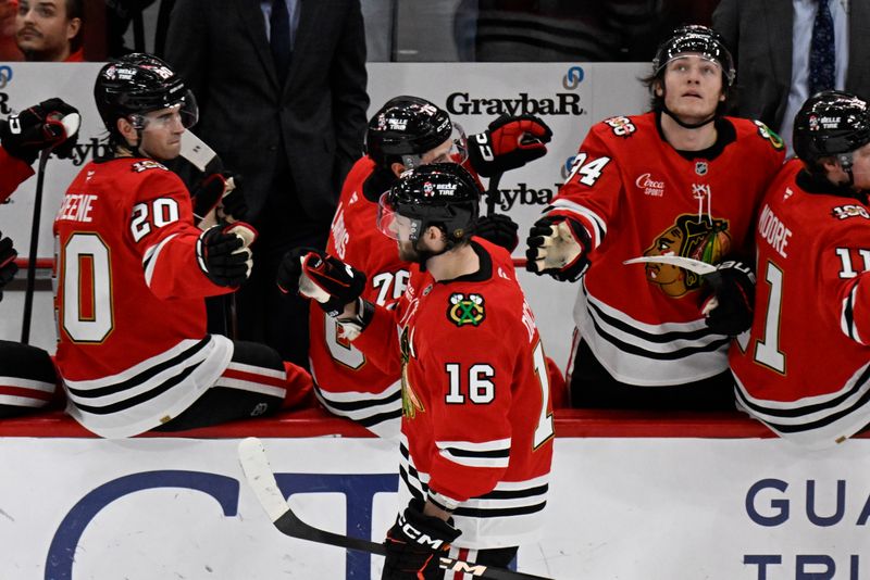 Jan 19, 2026; Chicago, Illinois, USA;  Chicago Blackhawks center Jason Dickinson (16) shakes hands with teammates on the bench after scoring a goal against Winnipeg Jets during the second period at United Center. Mandatory Credit: Matt Marton-Imagn Images