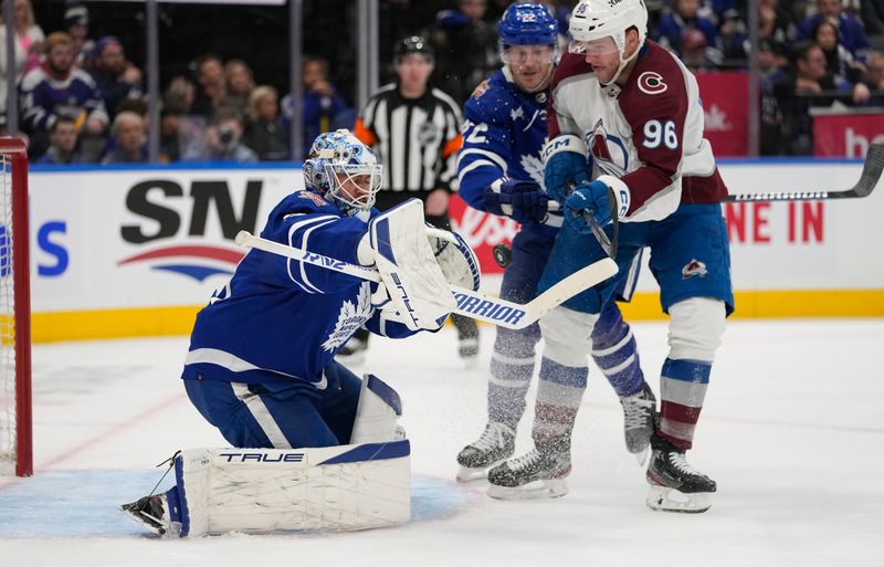 Jan 13, 2024; Toronto, Ontario, CAN; Toronto Maple Leafs goaltender Martin Jones (31) makes a save as Colorado Avalanche forward Mikko Rantanen (96) tries to knock in the rebound during the second period at Scotiabank Arena. Mandatory Credit: John E. Sokolowski-USA TODAY Sports