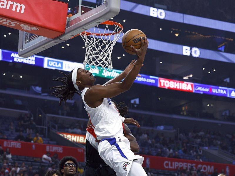 LOS ANGELES, CALIFORNIA - DECEMBER 11:  Terance Mann #14 of the LA Clippers takes a shot against the Portland Trail Blazers in the first half at Crypto.com Arena on December 11, 2023 in Los Angeles, California.  NOTE TO USER: User expressly acknowledges and agrees that, by downloading and/or using this photograph, user is consenting to the terms and conditions of the Getty Images License Agreement. (Photo by Ronald Martinez/Getty Images)