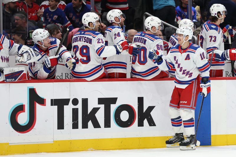 Dec 23, 2025; Washington, District of Columbia, USA; New York Rangers left wing Artemi Panarin (10) celebrates with teammates after scoring a goal against the Washington Capitals during the third period at Capital One Arena. Mandatory Credit: Geoff Burke-Imagn Images