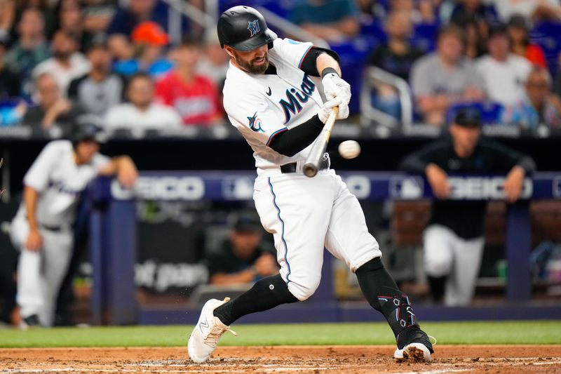 Jul 23, 2023; Miami, Florida, USA; Miami Marlins shortstop Jon Berti (5) hits a double against the Colorado Rockies during the second inning at loanDepot Park. Mandatory Credit: Rich Storry-USA TODAY Sports