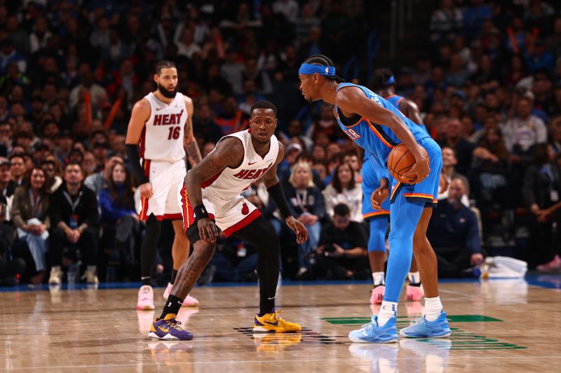 OKLAHOMA CITY, OK - MARCH 8:  Shai Gilgeous-Alexander #2 of the Oklahoma City Thunder handles the ball during the game as Terry Rozier #2 of the Miami Heat plays defense on March 8, 2024 at Paycom Arena in Oklahoma City, Oklahoma. NOTE TO USER: User expressly acknowledges and agrees that, by downloading and or using this photograph, User is consenting to the terms and conditions of the Getty Images License Agreement. Mandatory Copyright Notice: Copyright 2024 NBAE (Photo by Zach Beeker/NBAE via Getty Images)