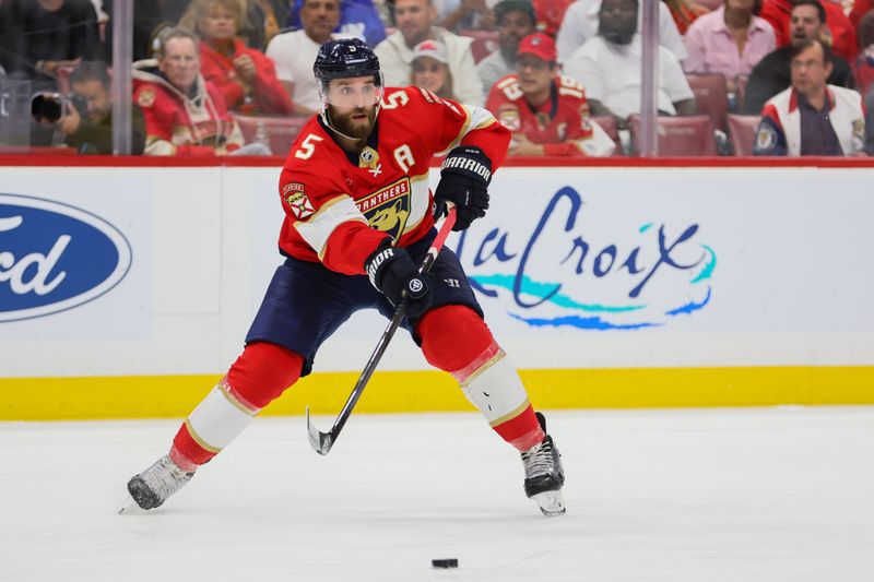 May 6, 2024; Sunrise, Florida, USA; Florida Panthers defenseman Aaron Ekblad (5) moves the puck against the Boston Bruins during the second period in game one of the second round of the 2024 Stanley Cup Playoffs at Amerant Bank Arena. Mandatory Credit: Sam Navarro-USA TODAY Sports