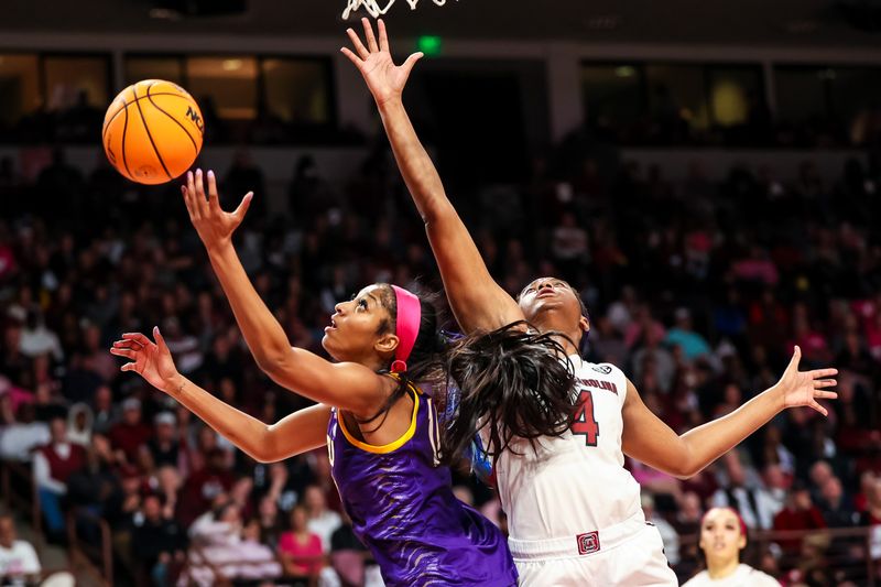 Feb 12, 2023; Columbia, South Carolina, USA; LSU Lady Tigers forward Angel Reese (10) grabs a rebound over South Carolina Gamecocks forward Aliyah Boston (4) in the second half at Colonial Life Arena. Mandatory Credit: Jeff Blake-USA TODAY Sports