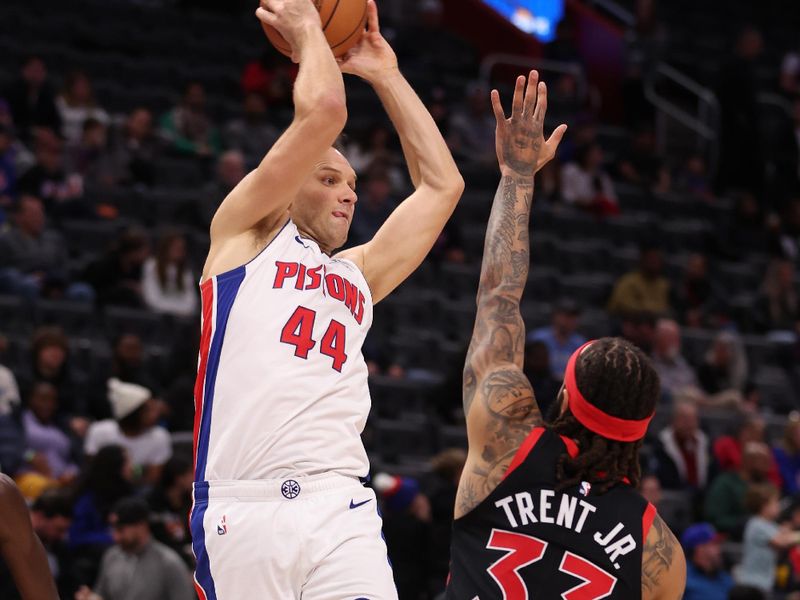 DETROIT, MICHIGAN - DECEMBER 30: Bojan Bogdanovic #44 of the Detroit Pistons passes over Gary Trent Jr. #33 of the Toronto Raptors during the first half at Little Caesars Arena on December 30, 2023 in Detroit, Michigan. NOTE TO USER: User expressly acknowledges and agrees that, by downloading and or using this photograph, User is consenting to the terms and conditions of the Getty Images License Agreement. (Photo by Gregory Shamus/Getty Images)