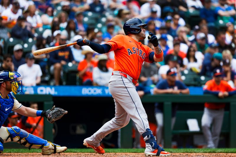 Jul 20, 2025; Seattle, Washington, USA; Houston Astros designated hitter Victor Caratini (17) hits a two-run double against the Seattle Mariners during the eighth inning at T-Mobile Park. Mandatory Credit: Joe Nicholson-Imagn Images