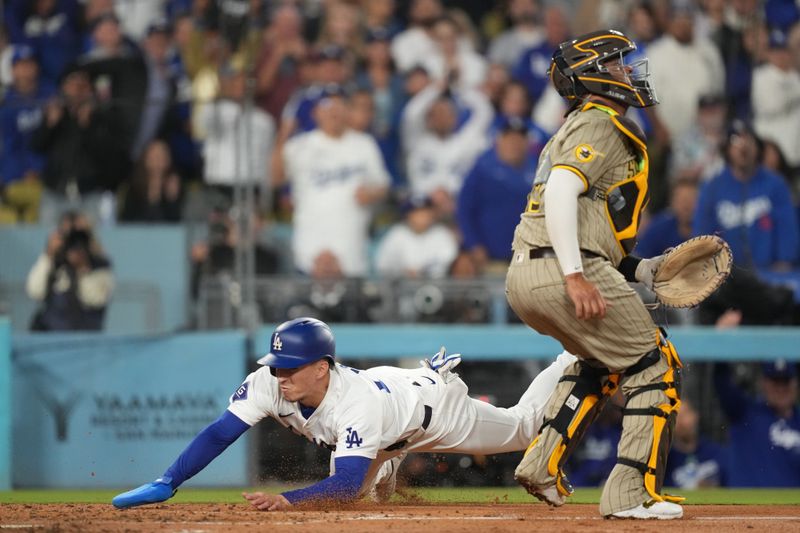 Sep 25, 2024; Los Angeles, California, USA;  Los Angeles Dodgers center fielder Tommy Edman (25) slides home to score a run while San Diego Padres catcher Elias Diaz (15) waits for a throw in the fourth inning at Dodger Stadium. Mandatory Credit: Kirby Lee-Imagn Images