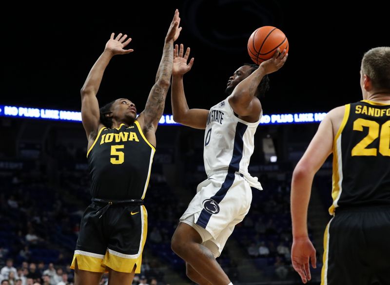 Feb 8, 2024; University Park, Pennsylvania, USA; Penn State Nittany Lions guard Kanye Clary (0) drives the ball to the basket as Iowa Hawkeyes guard Dasonte Bowen (5) defends during the first half at Bryce Jordan Center. Penn State defeated Iowa 89-79. Mandatory Credit: Matthew O'Haren-USA TODAY Sports