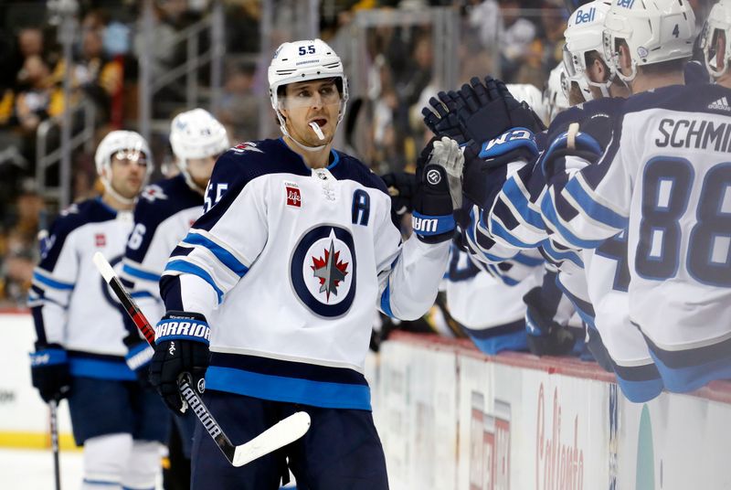 Jan 13, 2023; Pittsburgh, Pennsylvania, USA;  Winnipeg Jets center Mark Scheifele (55) celebrates with the Jets bench after scoring his second goal of the game against at PPG Paints Arena. The Jets won 4-1. Mandatory Credit: Charles LeClaire-USA TODAY Sports