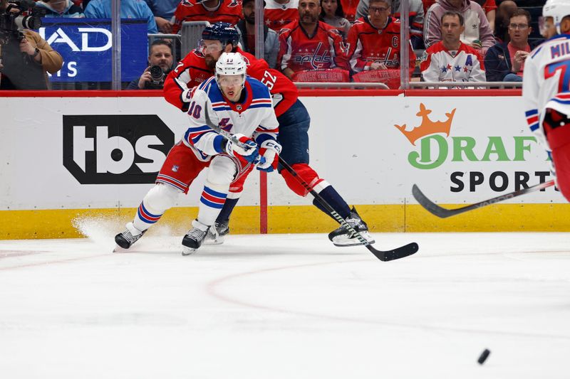 Apr 28, 2024; Washington, District of Columbia, USA; New York Rangers left wing Artemi Panarin (10) passes the puck as Washington Capitals defenseman Dylan McIlrath (52) defends in the first period in game four of the first round of the 2024 Stanley Cup Playoffs at Capital One Arena. Mandatory Credit: Geoff Burke-USA TODAY Sports