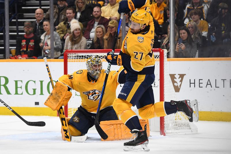 Dec 7, 2023; Nashville, Tennessee, USA; Nashville Predators defenseman Ryan McDonagh (27) tries to avoid being hit by a shot on goaltender Juuse Saros (74) during the second period against the Tampa Bay Lightning at Bridgestone Arena. Mandatory Credit: Christopher Hanewinckel-USA TODAY Sports