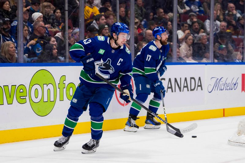 Jan 24, 2024; Vancouver, British Columbia, CAN; Vancouver Canucks defenseman Quinn Hughes (43) and defenseman Filip Hronek (17) regroup on the power paly against the St. Louis Blues in the second period at Rogers Arena. Mandatory Credit: Bob Frid-USA TODAY Sports